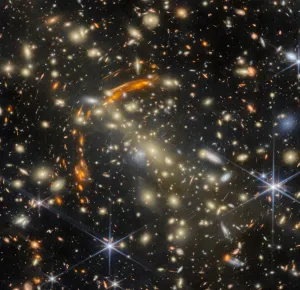 Galaxies warp and multiply as if in a house of mirrors in this image from NASA’s James Webb Space Telescope released on Sept. 29, 2026.